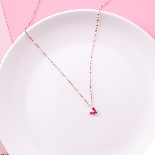 Dainty rose gold necklace with a small pink magenta stone heart pendant, vibrant gemstone jewelry for women.