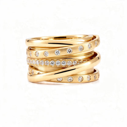 A polished 18K gold statement ring with multiple intertwined bands, featuring rows of small round diamonds, displayed centered on a pure white background.