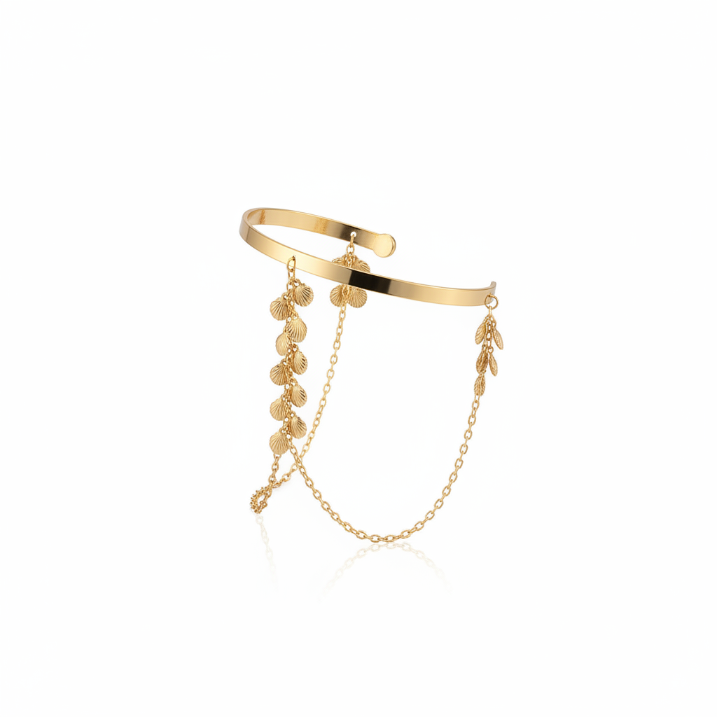 Gold layered cuff bracelet with chain and leaf charms on a white background
