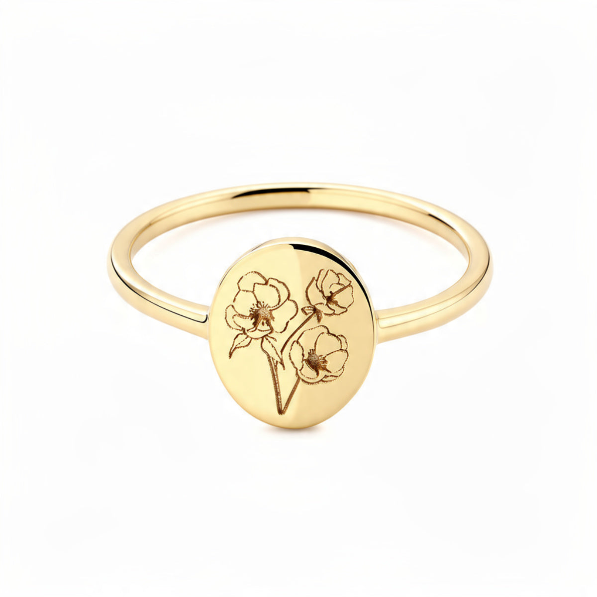Delicate gold signet ring on pure white background with engraved botanical flower bouquet on oval disc, thin polished band, minimalist floral jewelry


