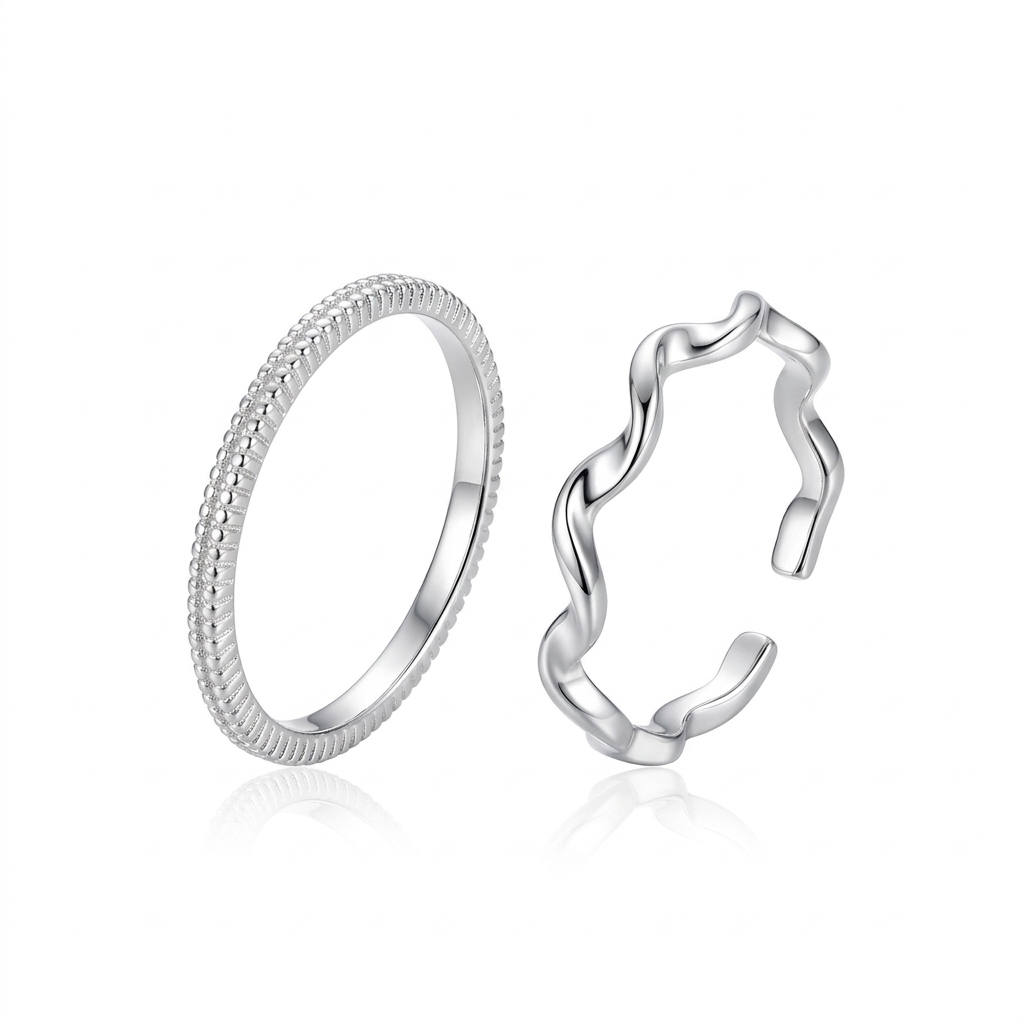 "Minimalist silver ring set featuring one textured beaded band and one adjustable wavy ripple band on a white background."