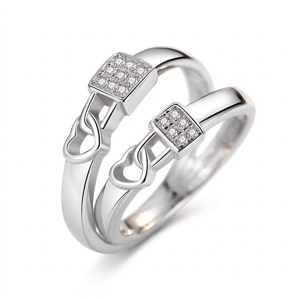 "Pair of silver heart-lock rings featuring a square centerpiece encrusted with shimmering crystals on a white background."