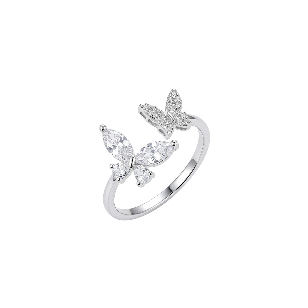 A silver adjustable open ring featuring two butterflies, one set with marquise-cut crystals and the other with small pavé stones, shown on a pure white background.