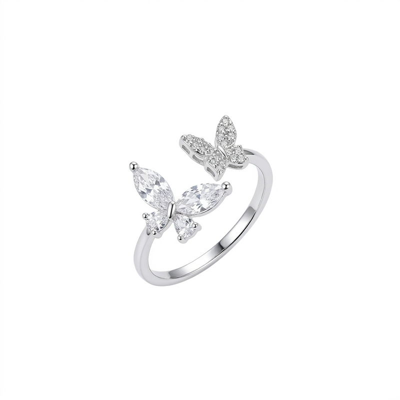 A silver adjustable open ring featuring two butterflies, one set with marquise-cut crystals and the other with small pavé stones, shown on a pure white background.