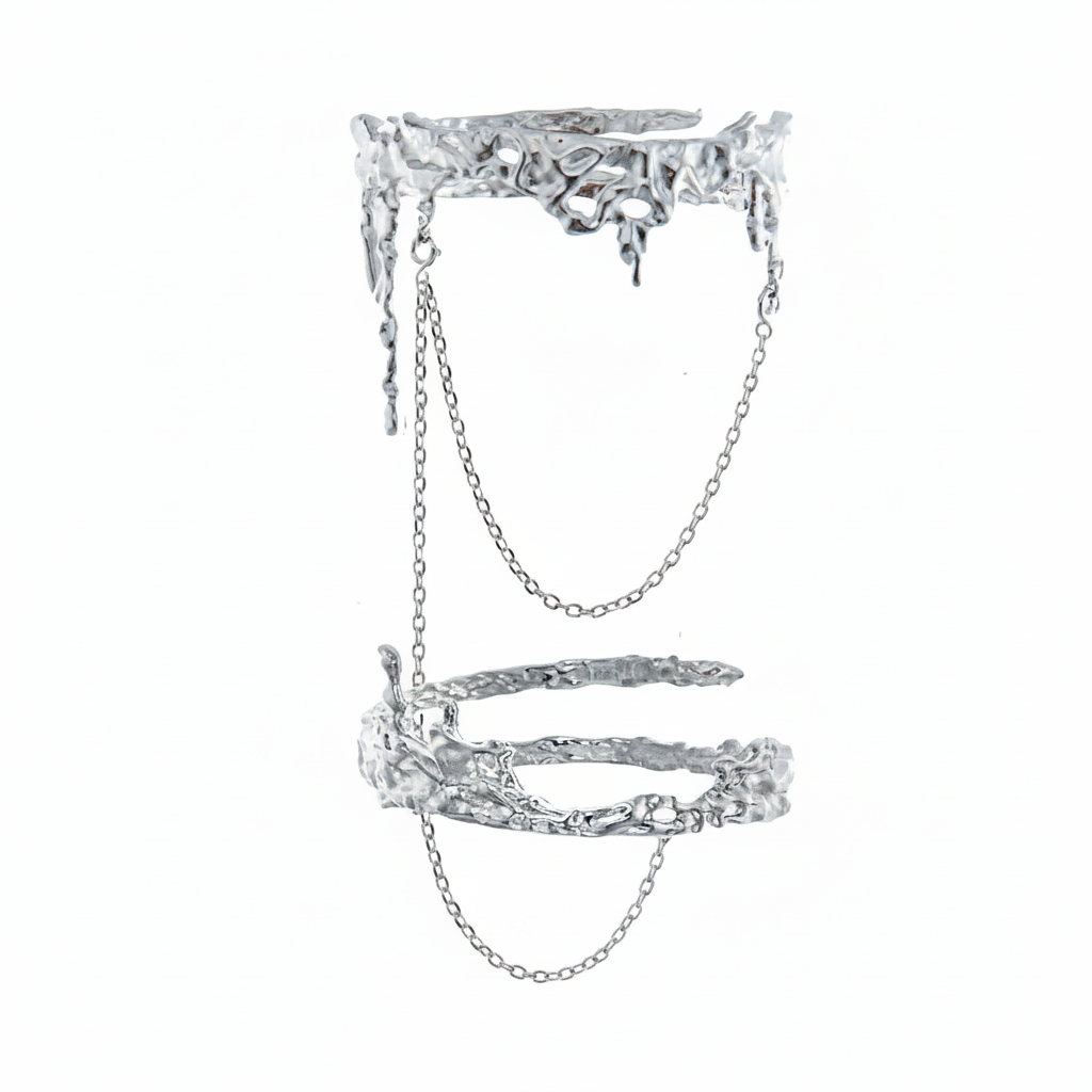 An avant-garde silver-toned double finger ring featuring a molten liquid-metal texture and delicate connecting chains, isolated on a white background.
