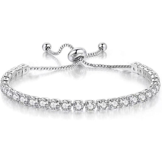 Silver tennis bracelet featuring a row of shimmering round-cut crystals with an adjustable slider bolo clasp on a white background.