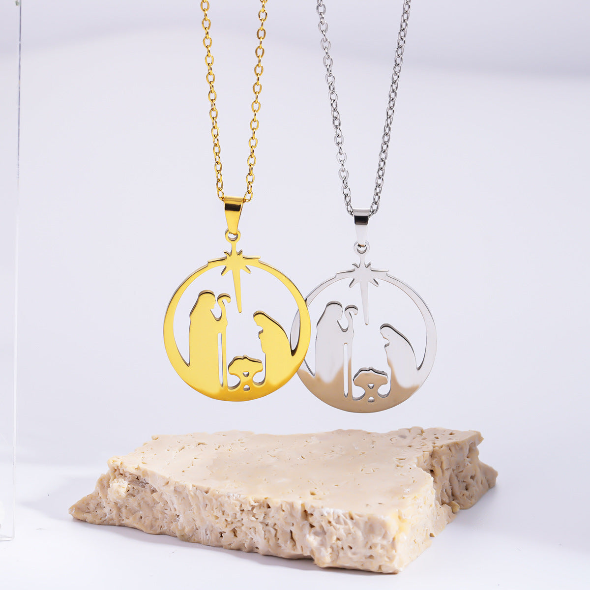 Stainless steel nativity scene pendant necklace in gold and silver finishes, minimalist religious jewelry for women.
