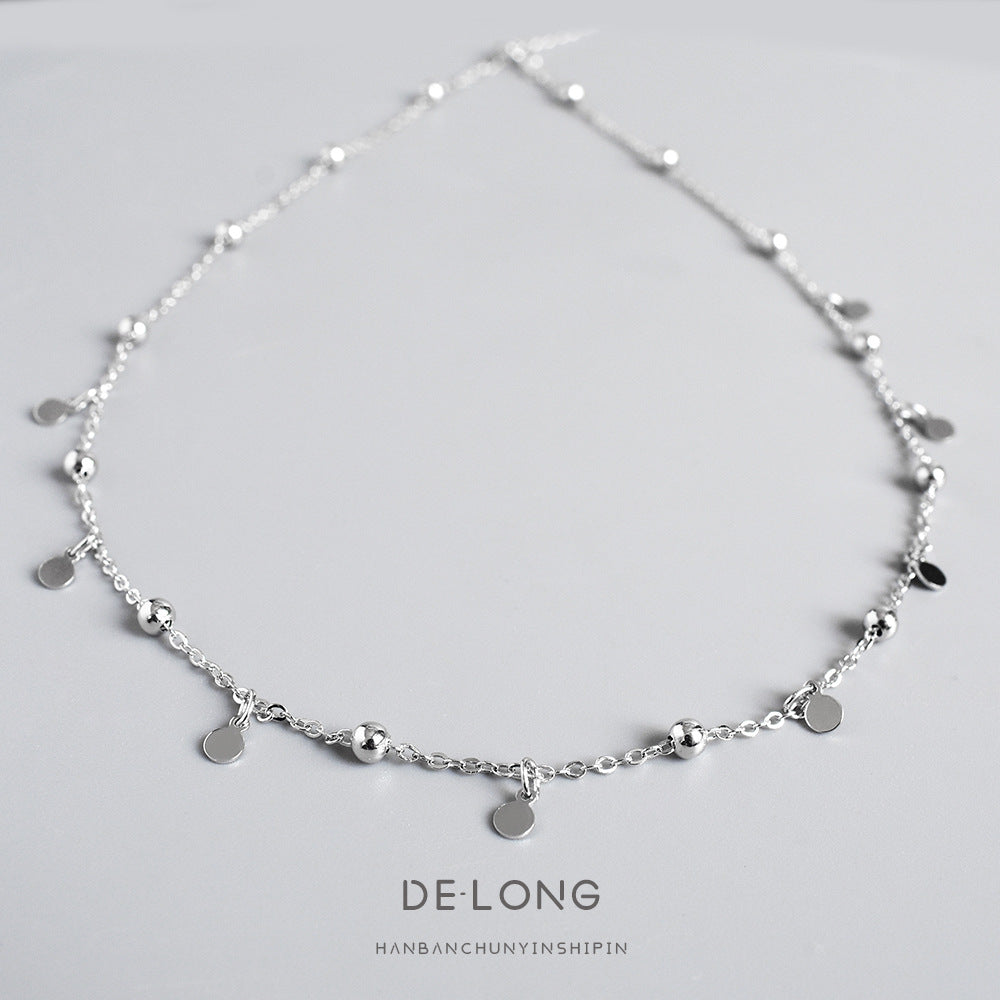 Sterling silver dainty choker necklace with small dangling discs and polished beads, minimalist geometric jewelry for women.