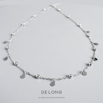 Sterling silver dainty choker necklace with small dangling discs and polished beads, minimalist geometric jewelry for women.