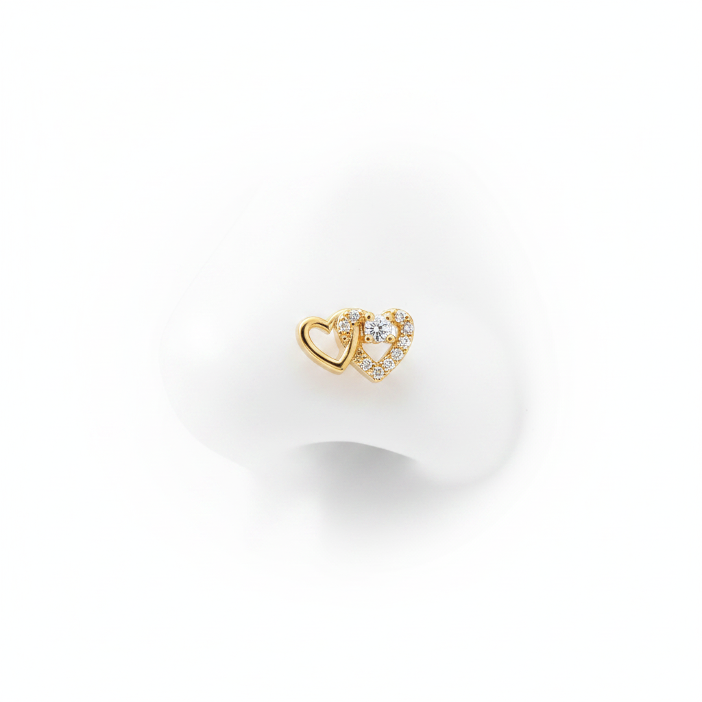 A luxury 18k gold-dipped nose stud featuring two interlocking hearts—one in polished gold and the other pavé-set with brilliant crystals—crafted from tarnish-resistant titanium steel for a minimalist editorial look.
