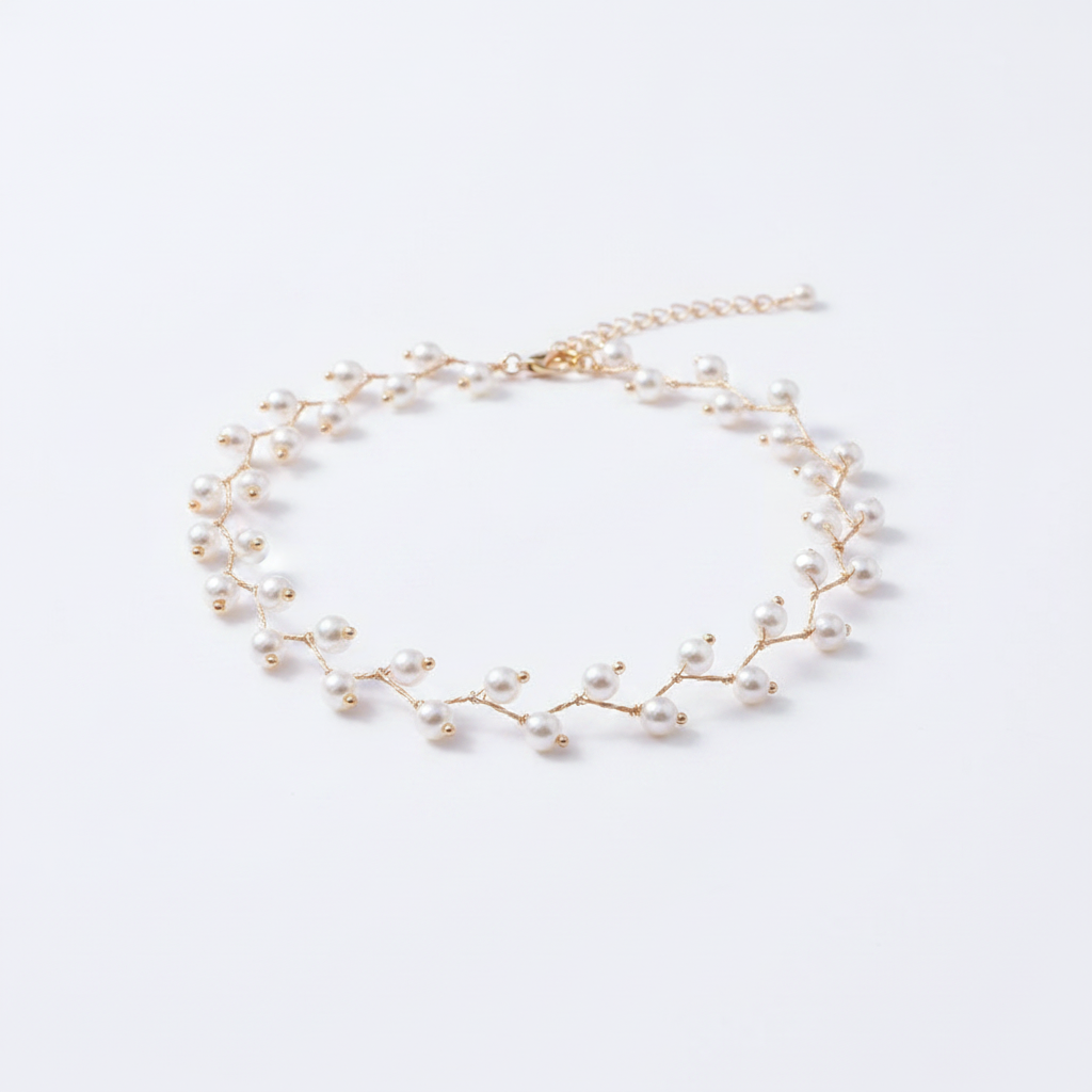 A delicate 18k gold-dipped choker featuring a branch-inspired silhouette adorned with small, radiant pearls, designed with a tarnish-resistant titanium steel base for a modern, high-end editorial aesthetic.