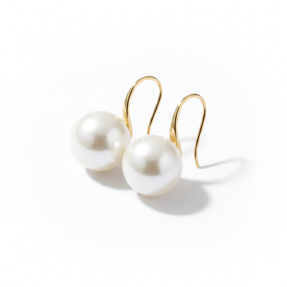 Minimalist 18k gold-dipped hook earrings featuring large, high-lustre white pearls, designed with a tarnish-resistant titanium steel base for a clean, modern editorial look.