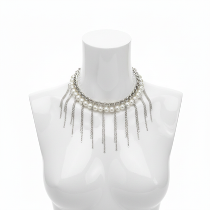 A striking statement choker featuring a row of luminous white pearls paired with a rugged silver-toned industrial chain and dramatic cascading fringe drops for a modern, high-fashion editorial aesthetic.