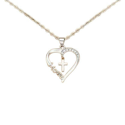 A two-tone heart pendant necklace on a rose gold chain. The open heart pendant features a silver-toned side pavé-set with clear crystals and a rose gold-toned side with the word "Mom" engraved in a flowing script. A small silver-toned cross hangs within the center of the heart. The jewelry is shown against a plain white background.