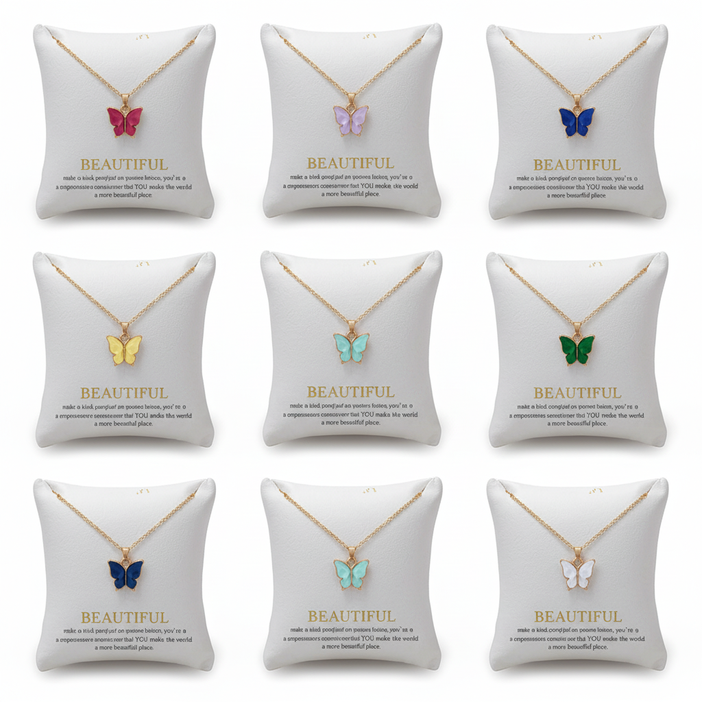 Multiple gold chain necklaces with colorful butterfly charms displayed on elegant white padded jewelry pillows