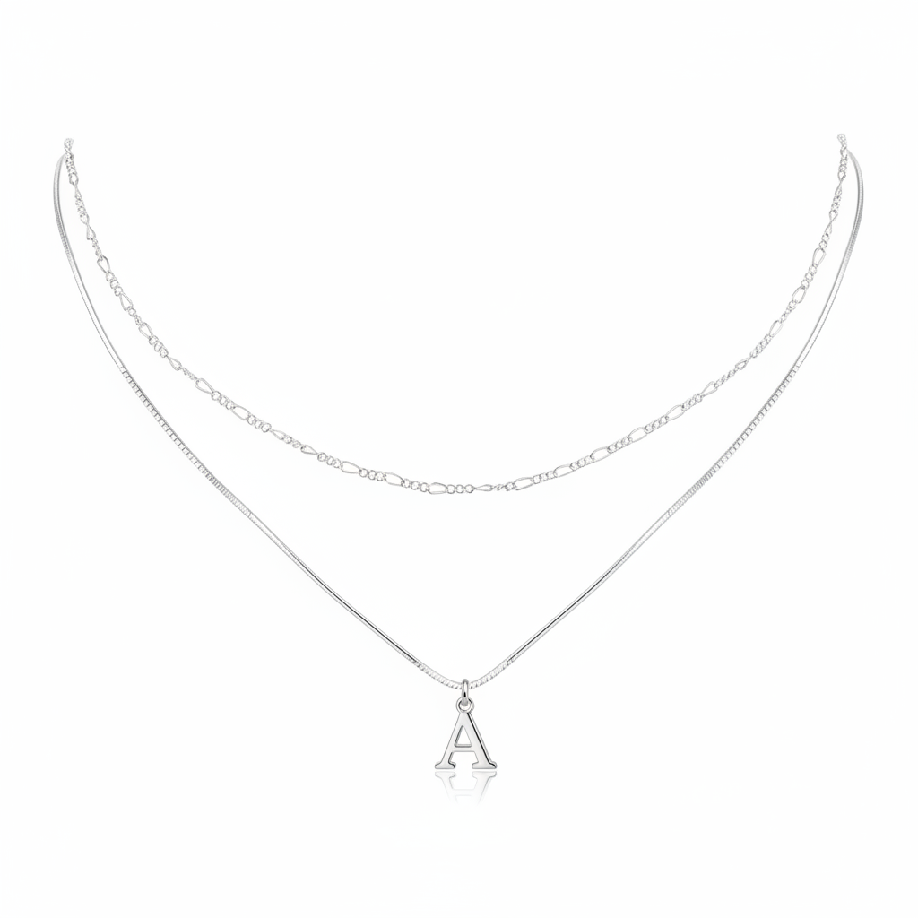 Minimalist silver layered necklace featuring a sleek snake chain with an initial A pendant and a delicate figaro link chain