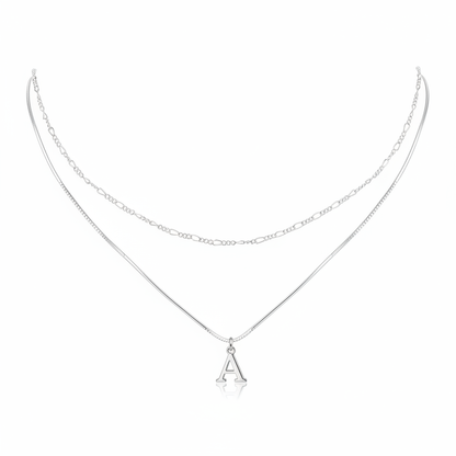 Minimalist silver layered necklace featuring a sleek snake chain with an initial A pendant and a delicate figaro link chain